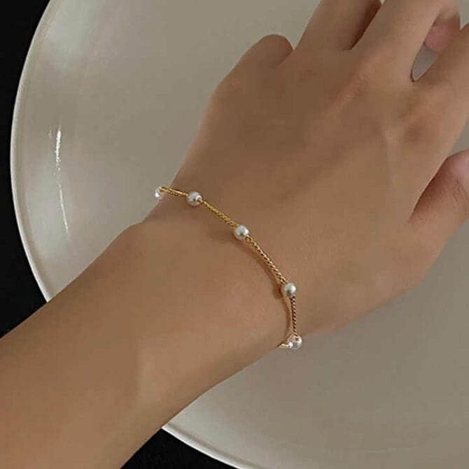 Adorn your wrist with the Celestial Alloy Bracelet—a graceful blend of gold and silver beads that dances like stardust, capturing the timeless allure of the cosmos in a modern, poetic embrace.
