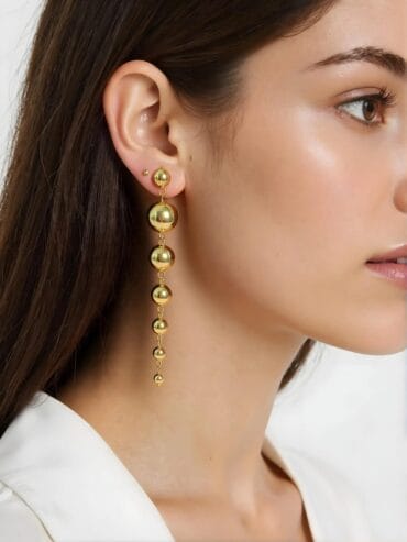 Adorn your ears with a sonnet of elegance. The Golden Ballad Earrings, a harmonious blend of gold-plated artistry and timeless charm, whisper tales of beauty and grace in every delicate curve.