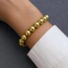 Golden Ballad Bracelet enchants with graceful, golden elegance. Its intricate design and shimmering gilded accents evoke a tender melody of artistry, capturing the allure of timeless charm.