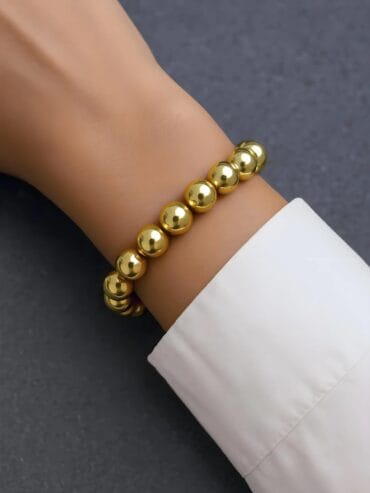 Golden Ballad Bracelet enchants with graceful, golden elegance. Its intricate design and shimmering gilded accents evoke a tender melody of artistry, capturing the allure of timeless charm.